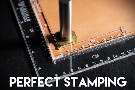 Two clear plastic right angle rulers with measurement markings demonstrating tool use on a dark surface with 'Castillo Heritage Crafts' branding and "perfect stamping" caption
