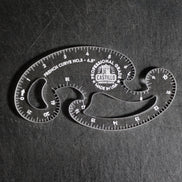 A clear plastic French Curve No. 3 measuring tool by Castello, shown on a dark textured background.